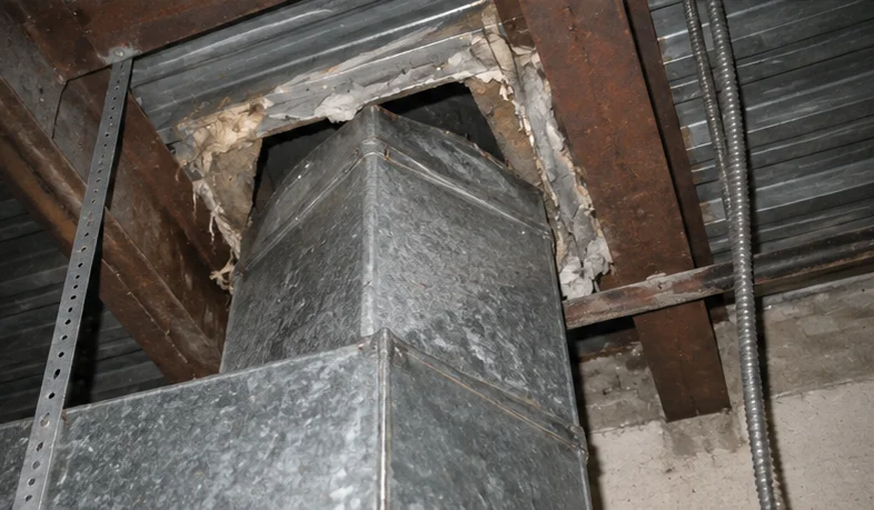 Illustrative reconstruction of an unsealed opening around commercial ductwork near a roof