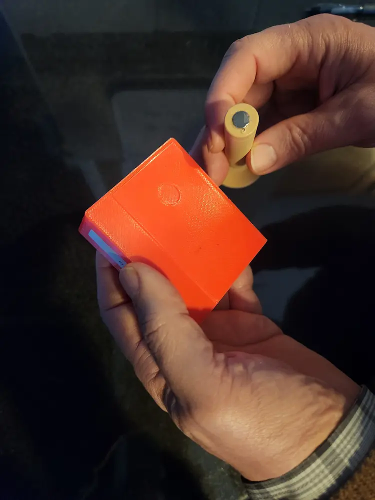 Showing the magnet, the small round disk.