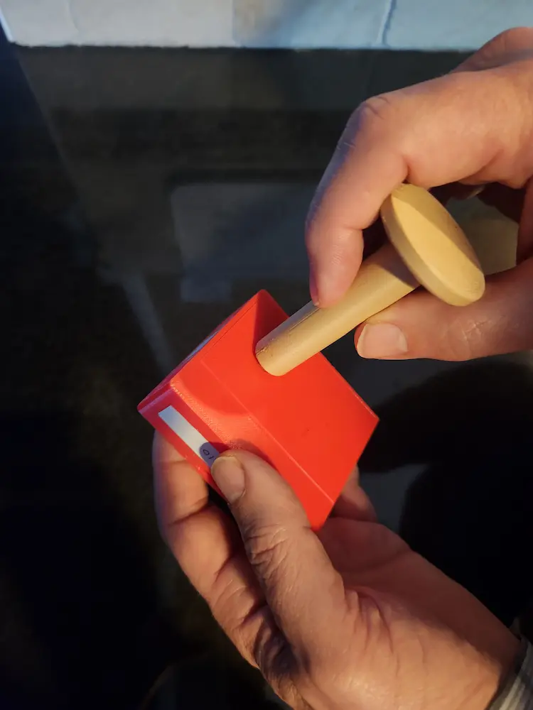 You'll see a round indent on the back of the sensor case.  Briefly place the magnet near or in that round area.